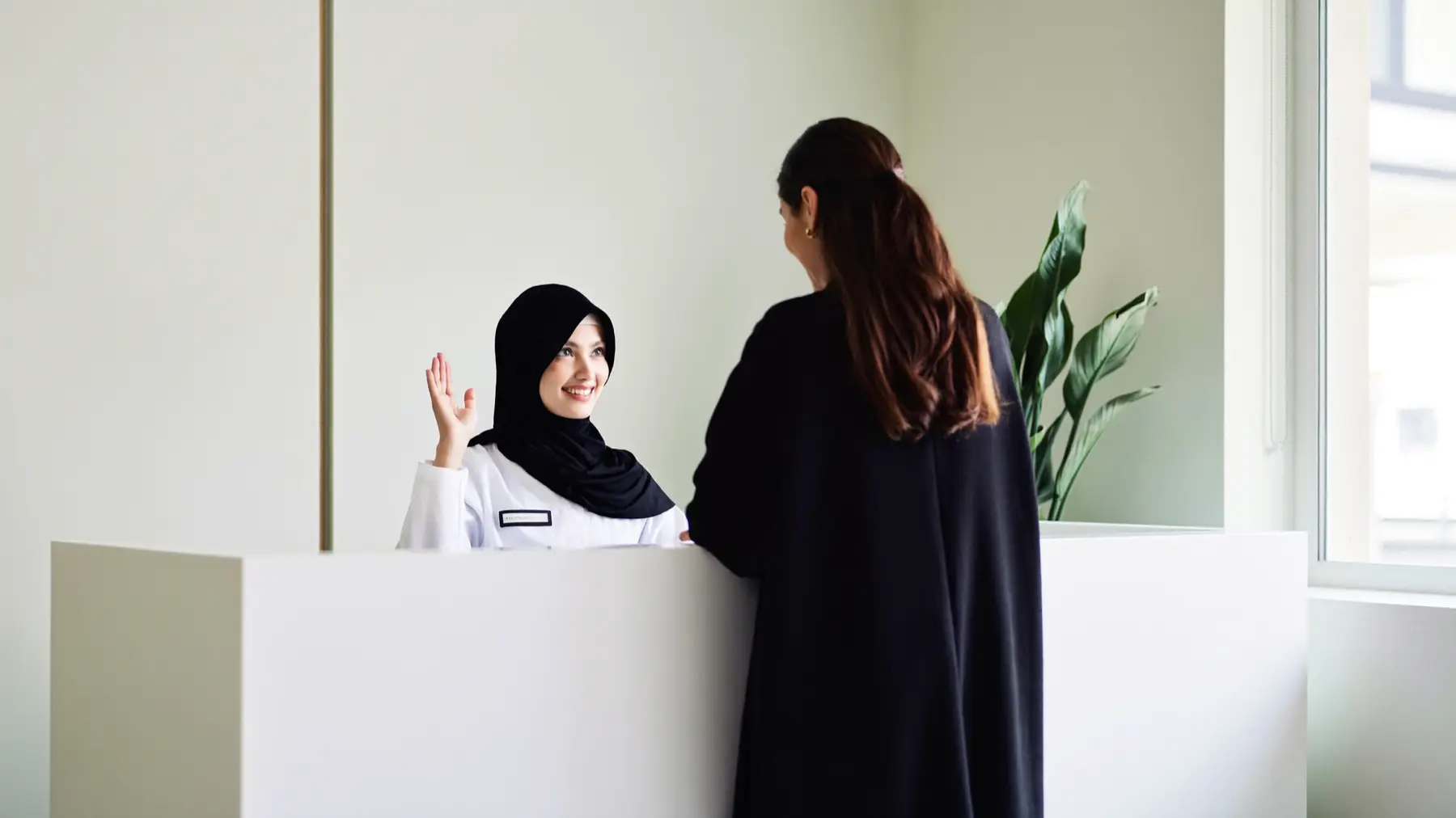 A receptionist welcoming a customer
